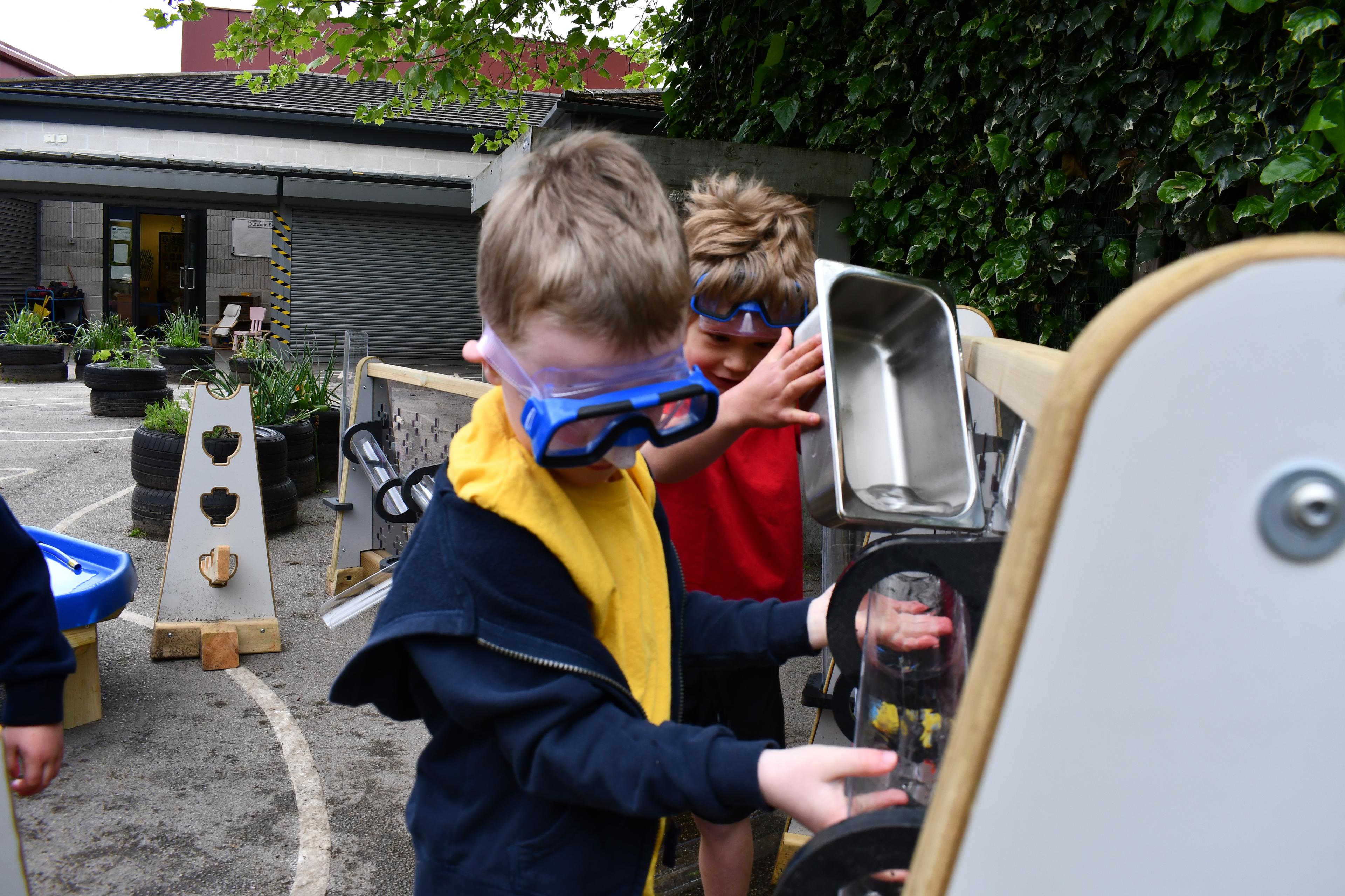 Children playing with the water wall that makes up part of the Pioneer Messy Play Package