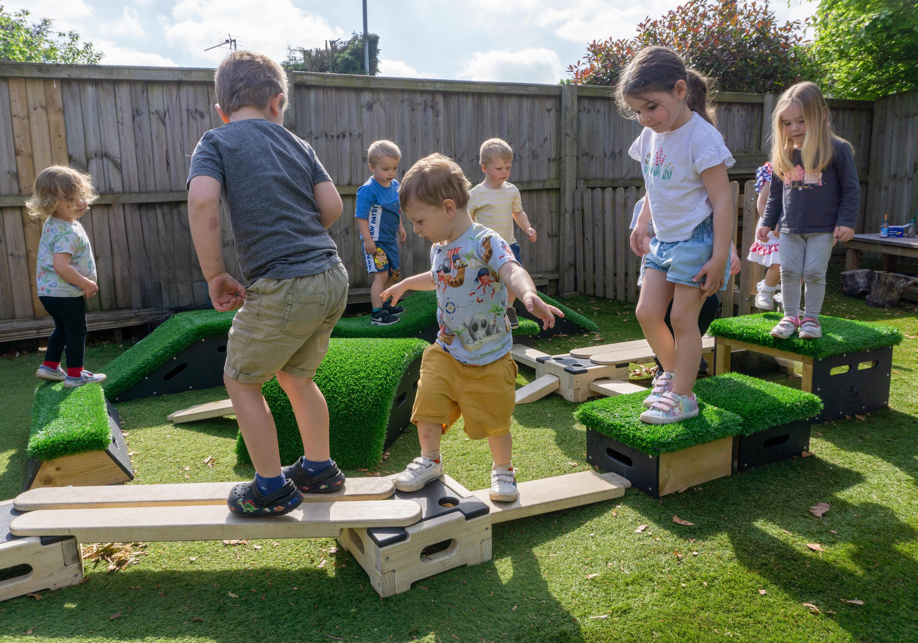 Young children playing on an obstacle course made from pieces of the Sports Premium Epic Explorer Package.