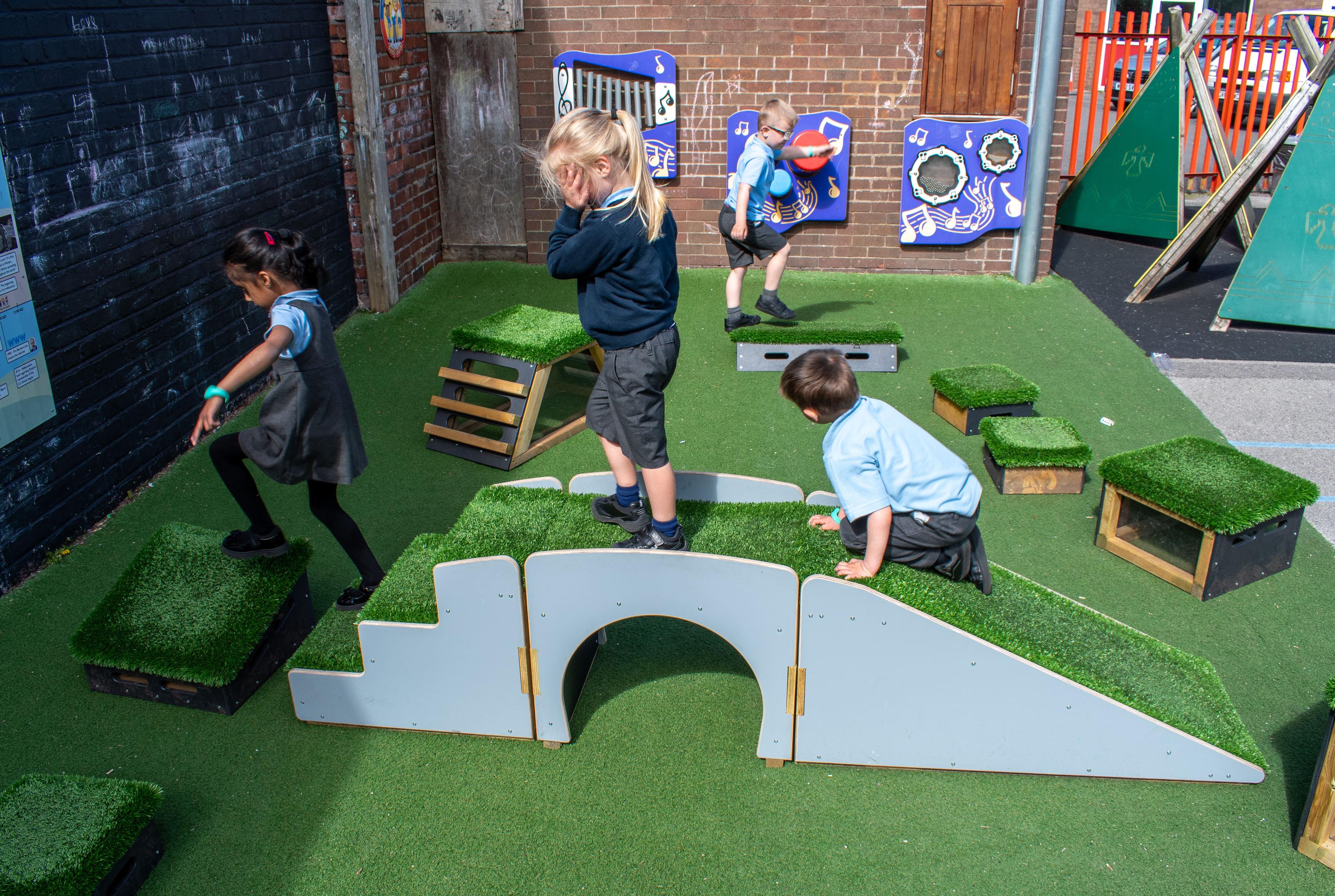 Children walking over the Up and Under pieces towards a Get Set Go Block.