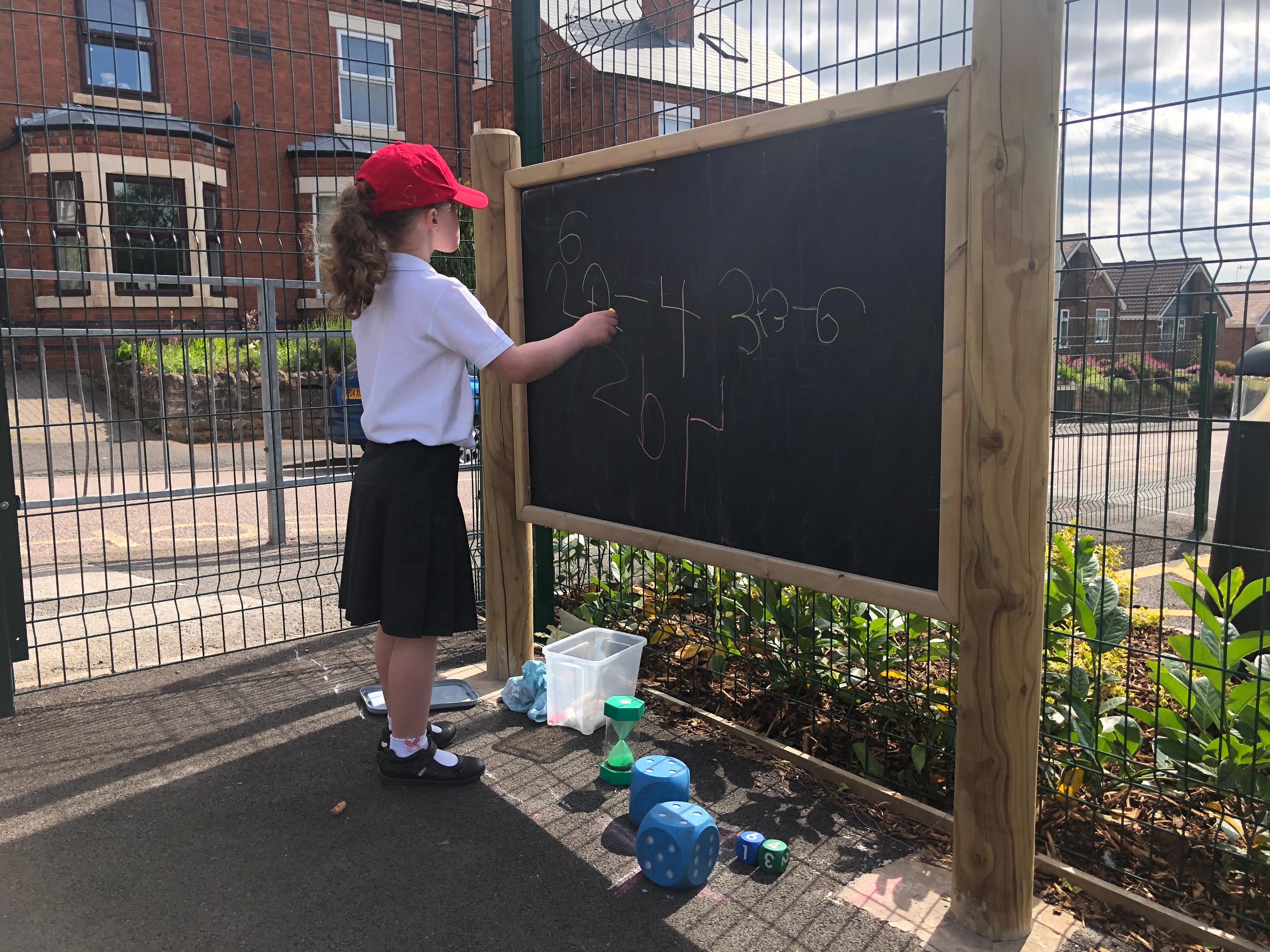 Giant wooden chalkboard on posts from Pentagon Play