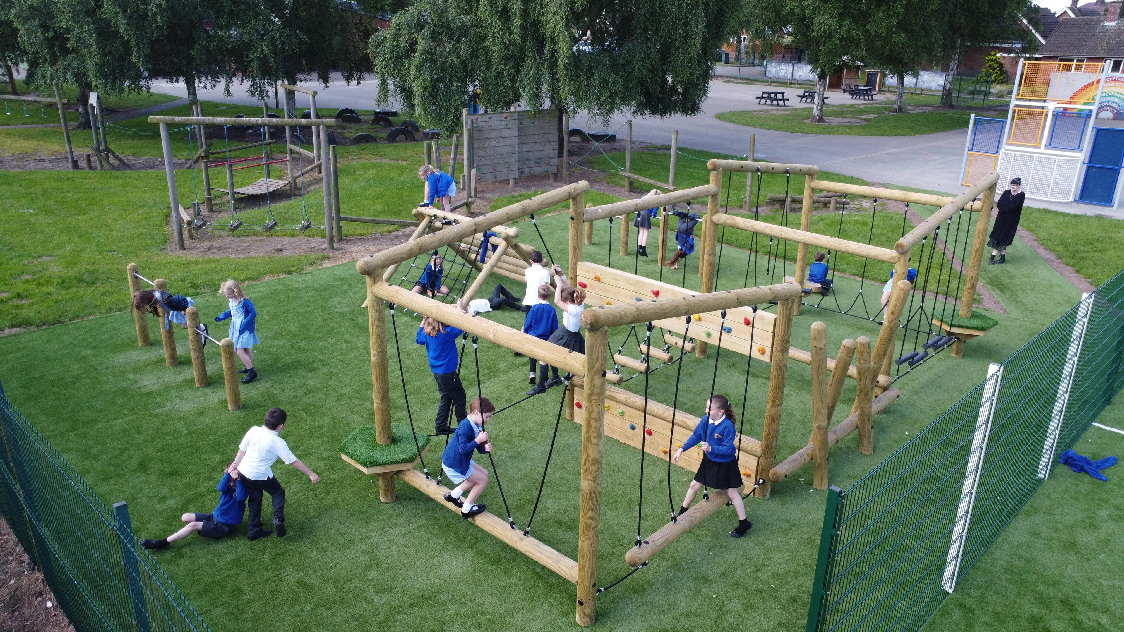 Wooden Kielder Forest Circuit Climbing Frame with multiple children playing on it.