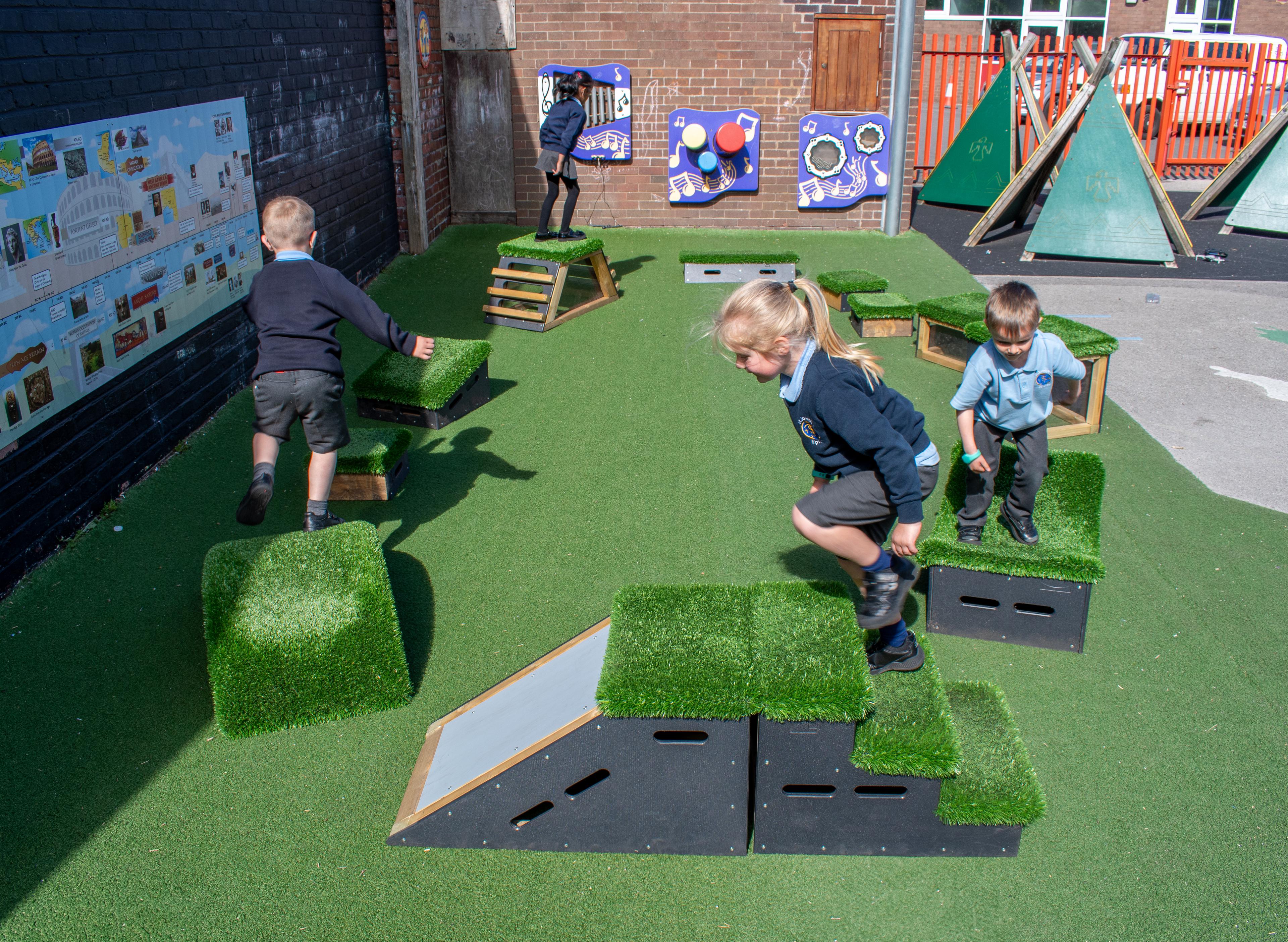 School children playing with grass-topped Get Set, Go! Blocks - The Mendips Set.