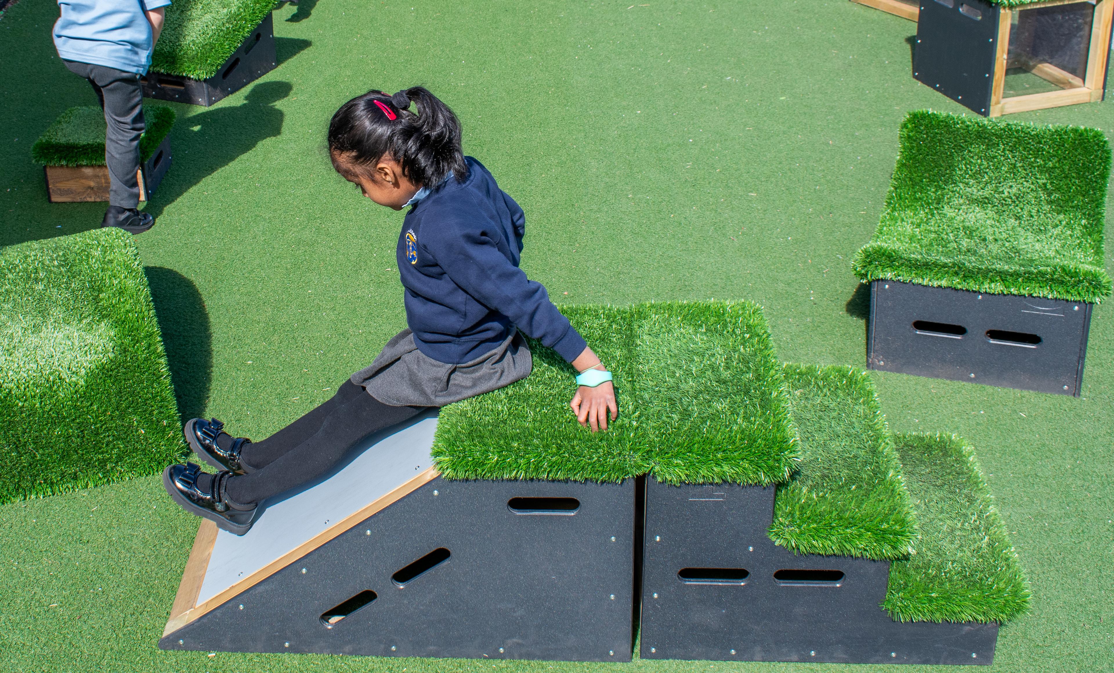 A child sliding down a Get Set, Go! block