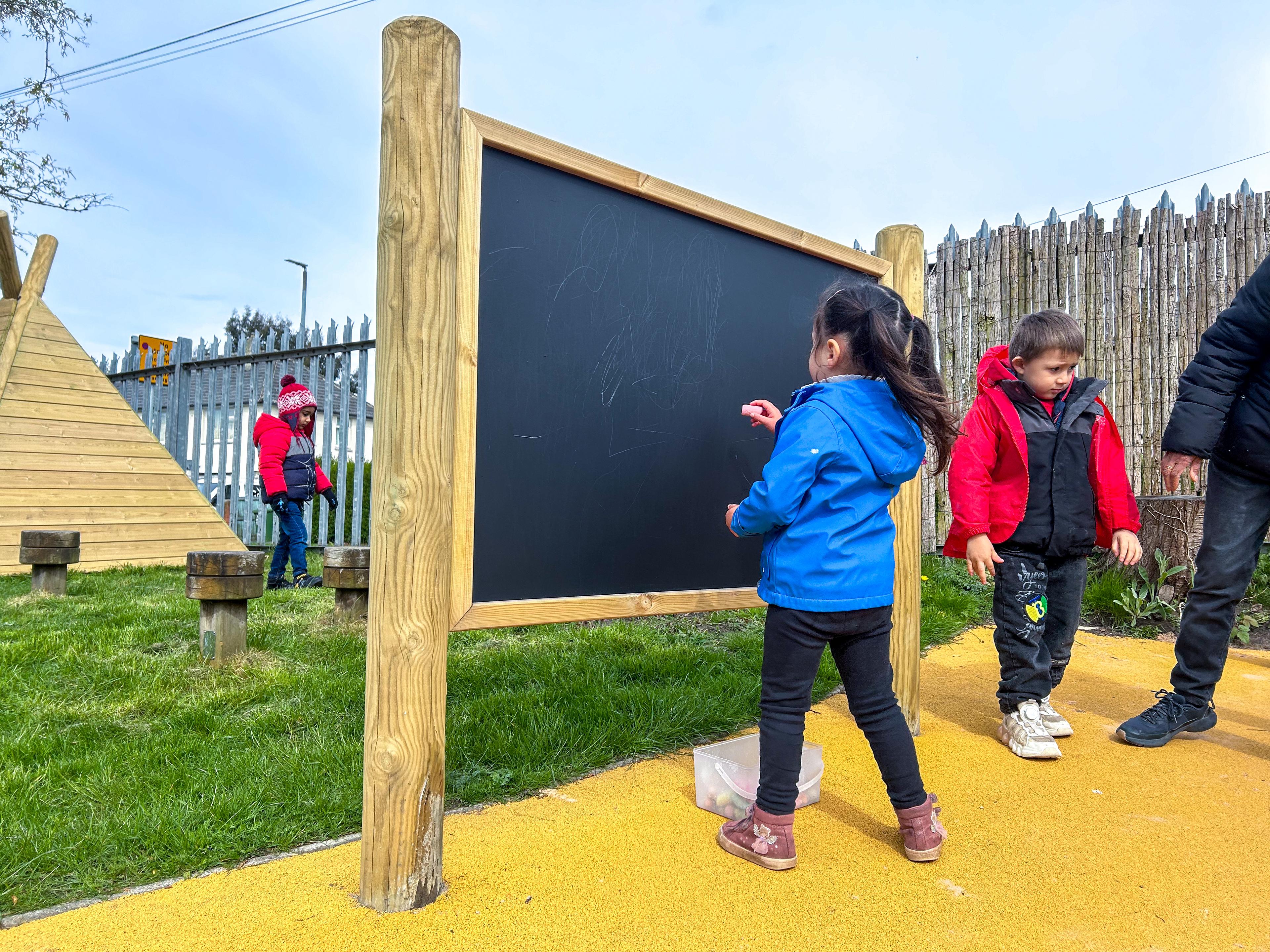 Giant wooden chalkboard on posts from Pentagon Play