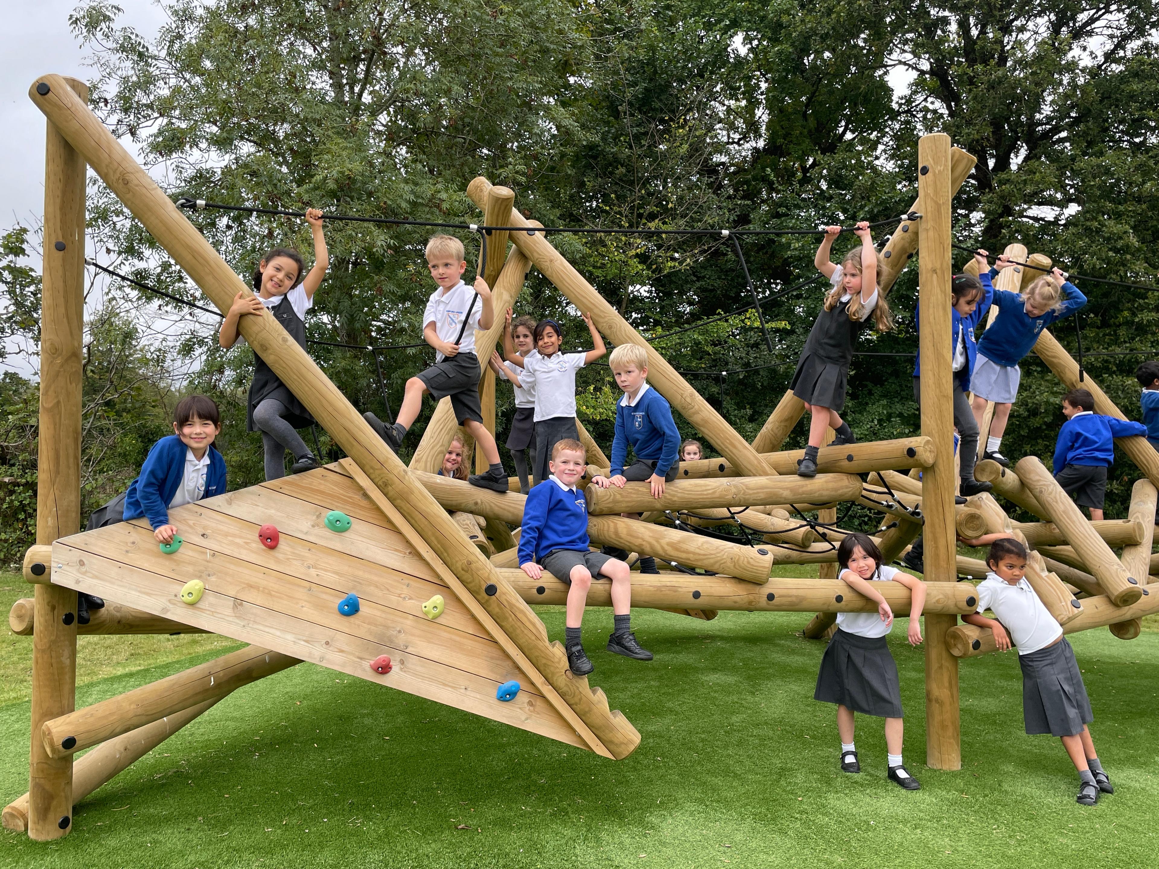 Wooden Crinkle Crags climbing frame in a school playground.