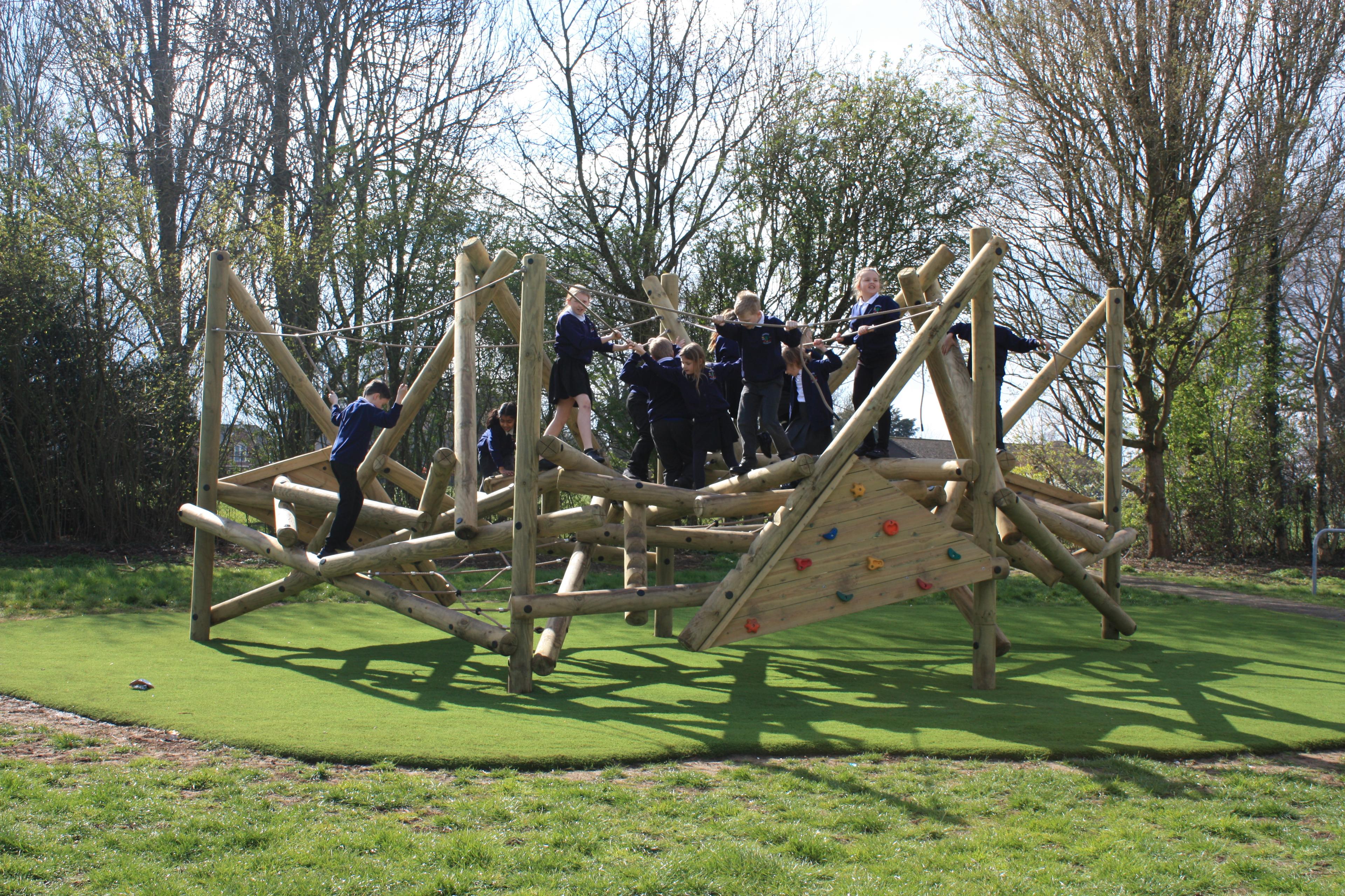 Wooden Crinkle Crags climbing frame in a school playground.