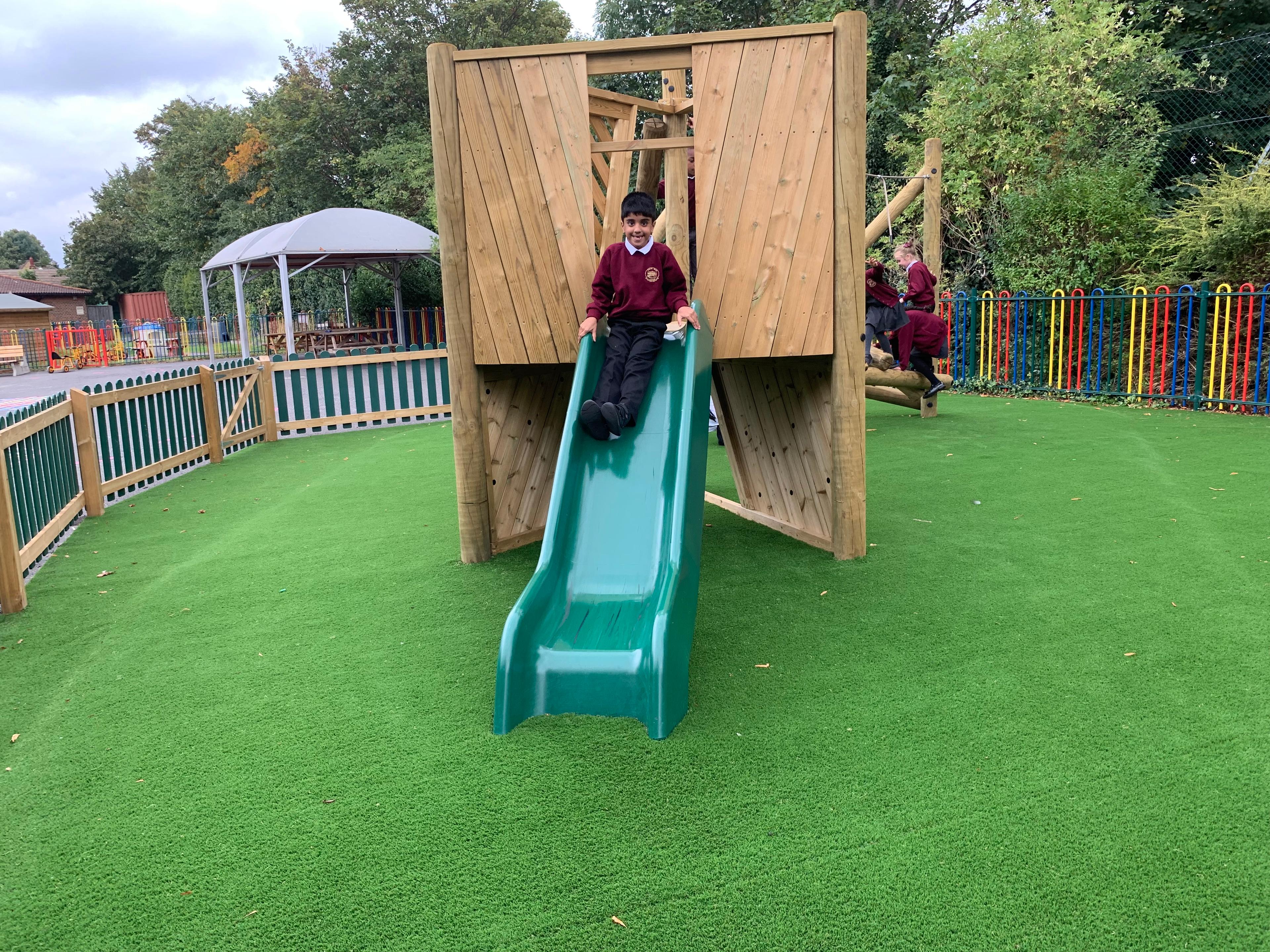 Wooden Bowfell Climbing Frame with Platform and Slide in school playground.