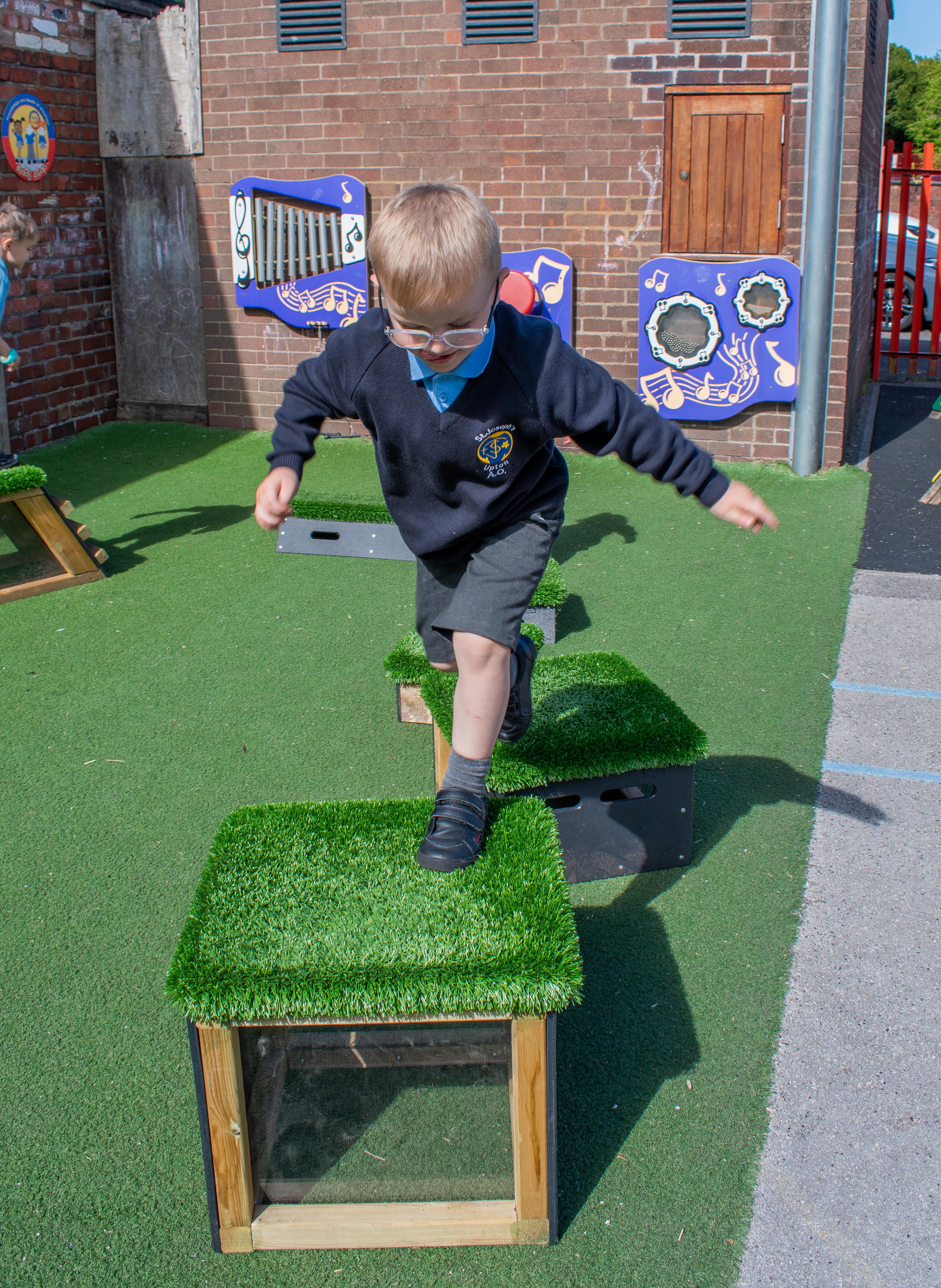 School children playing with grass-topped Get Set, Go! Blocks - The Mendips Set.