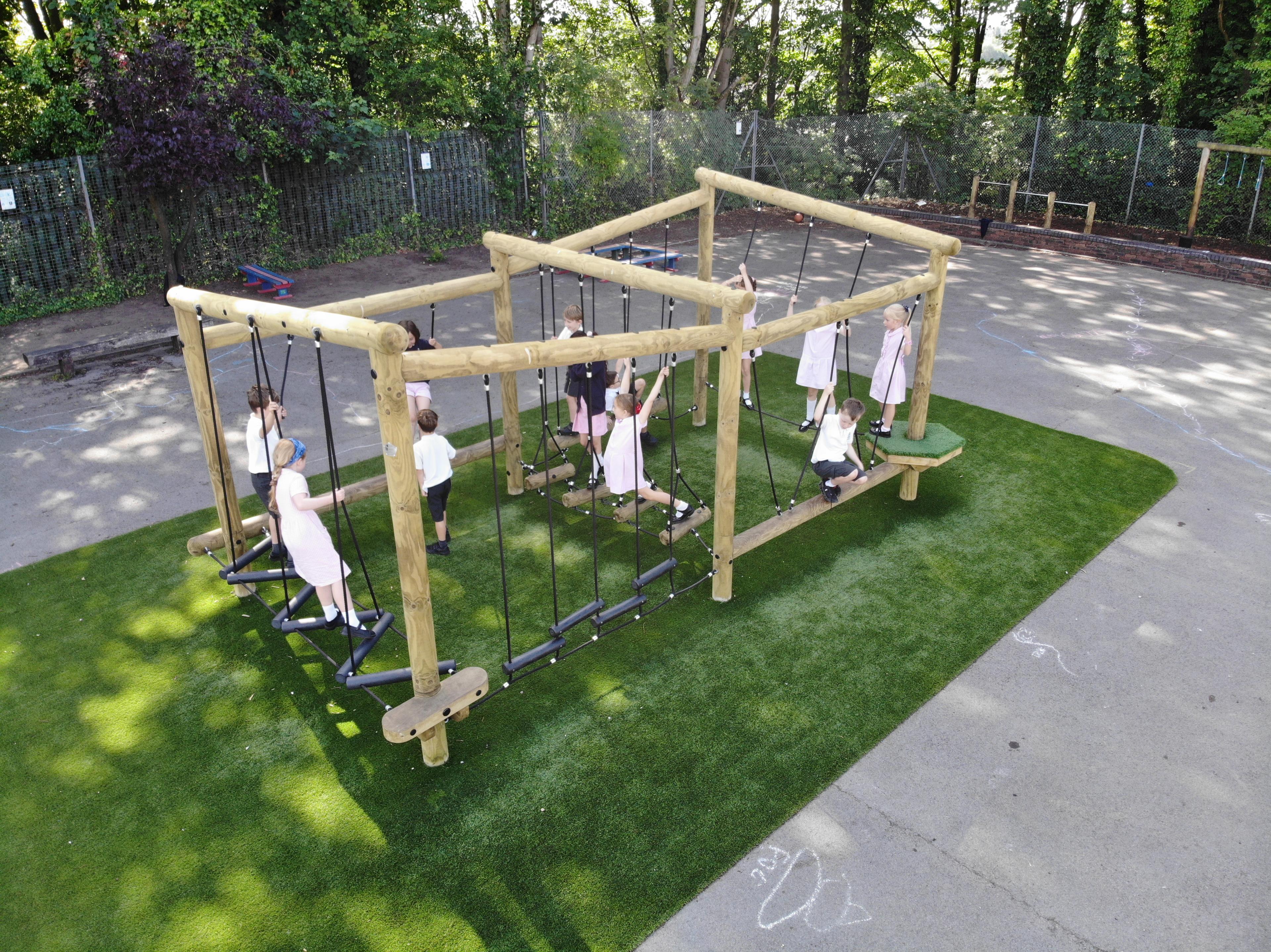 A wooden climbing frame with children on it