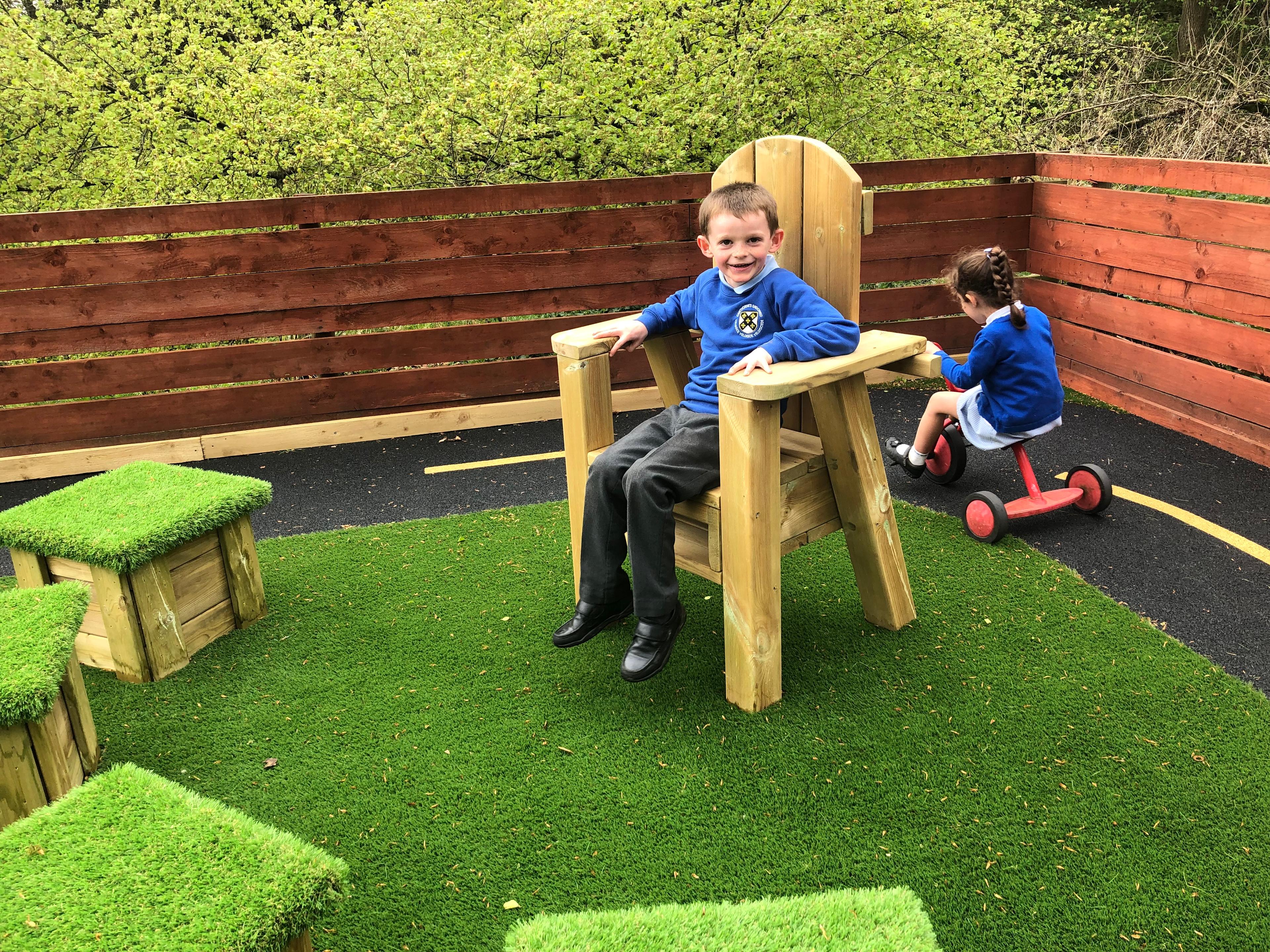 a boy sat in the storytelling chair
