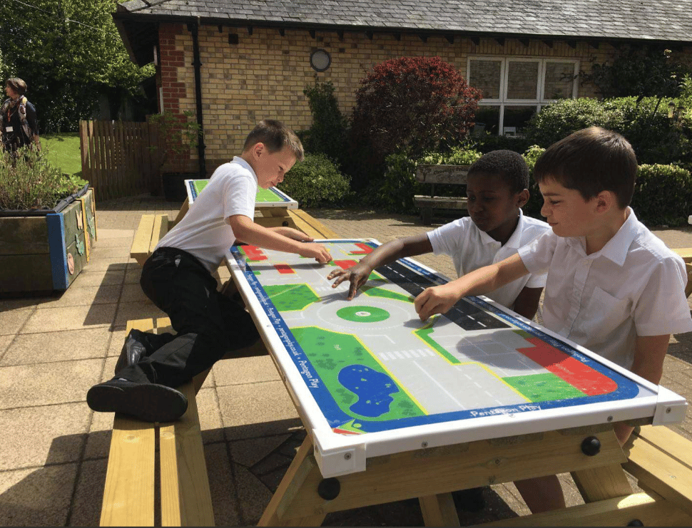 A Pentagon Play bespoke School Playground Scheme with children playing on the playground