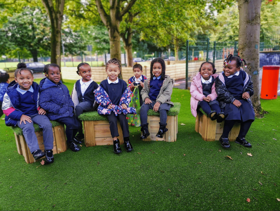 A Pentagon Play bespoke School Playground Scheme with children playing on the playground