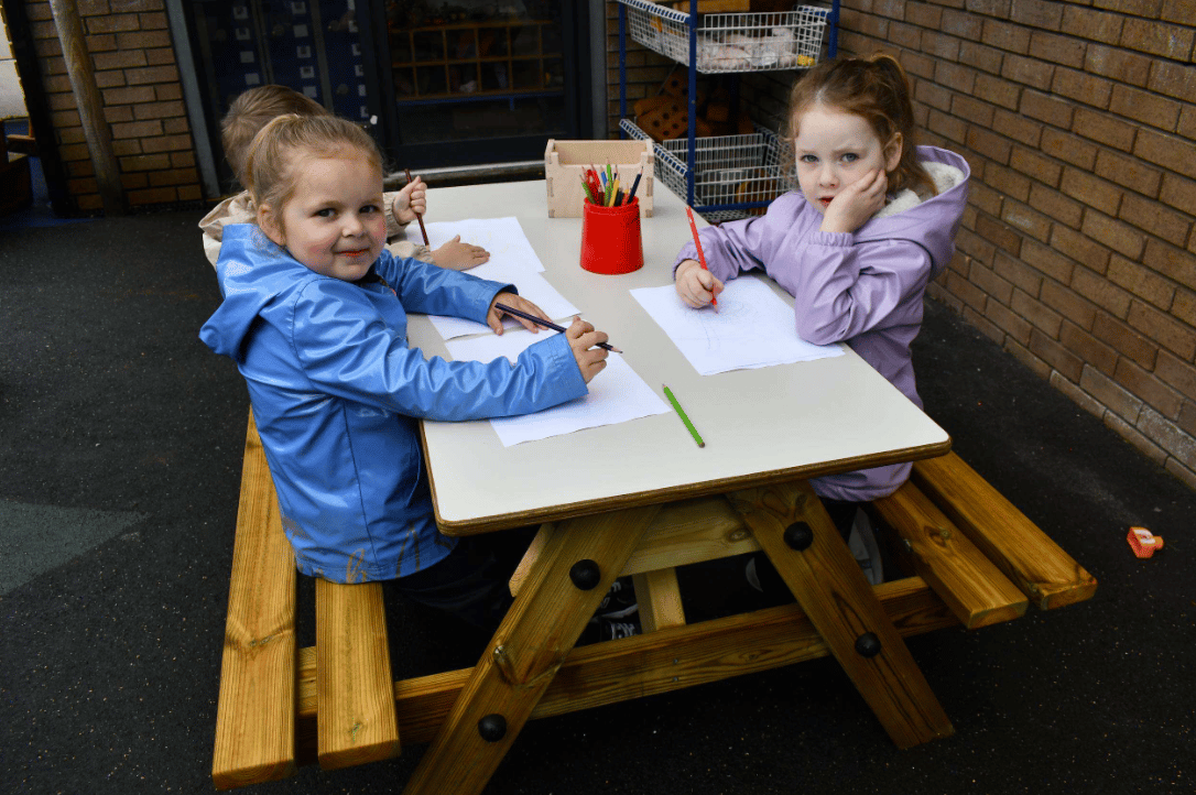 A Pentagon Play bespoke School Playground Scheme with children playing on the playground