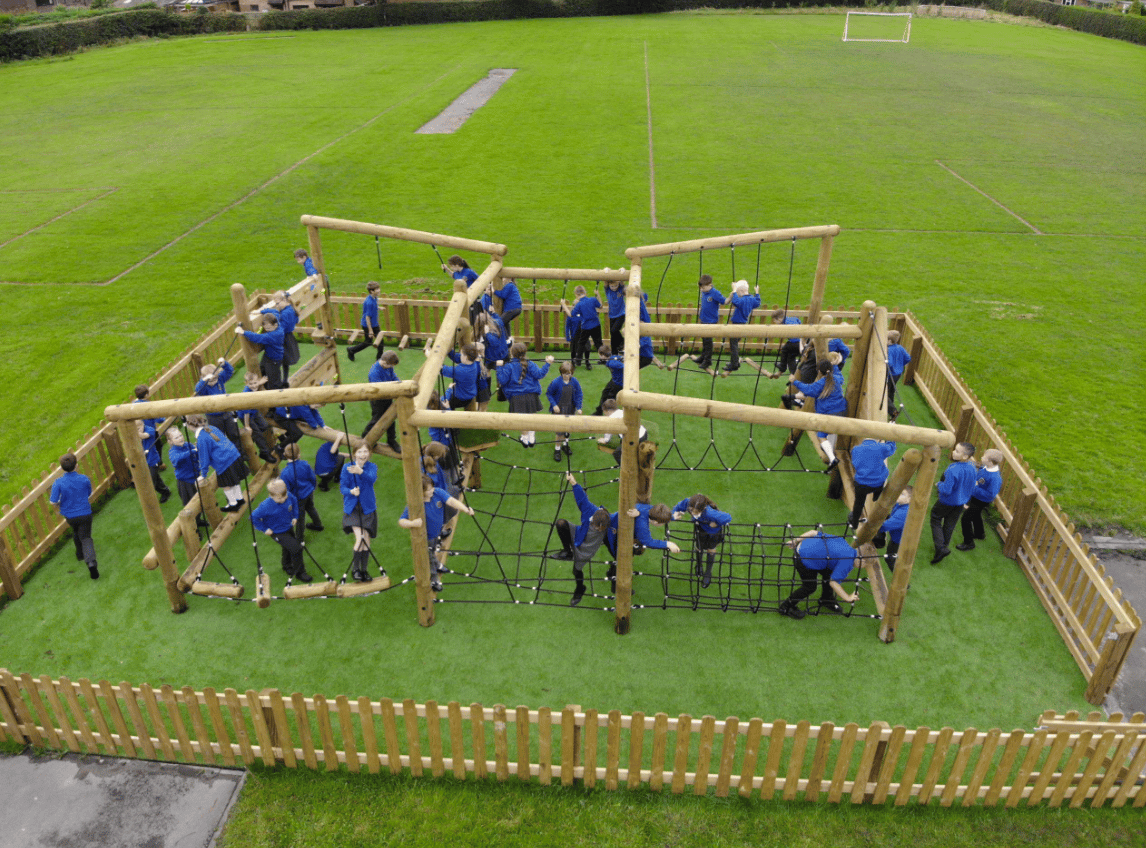A Pentagon Play bespoke School Playground Scheme with children playing on the playground