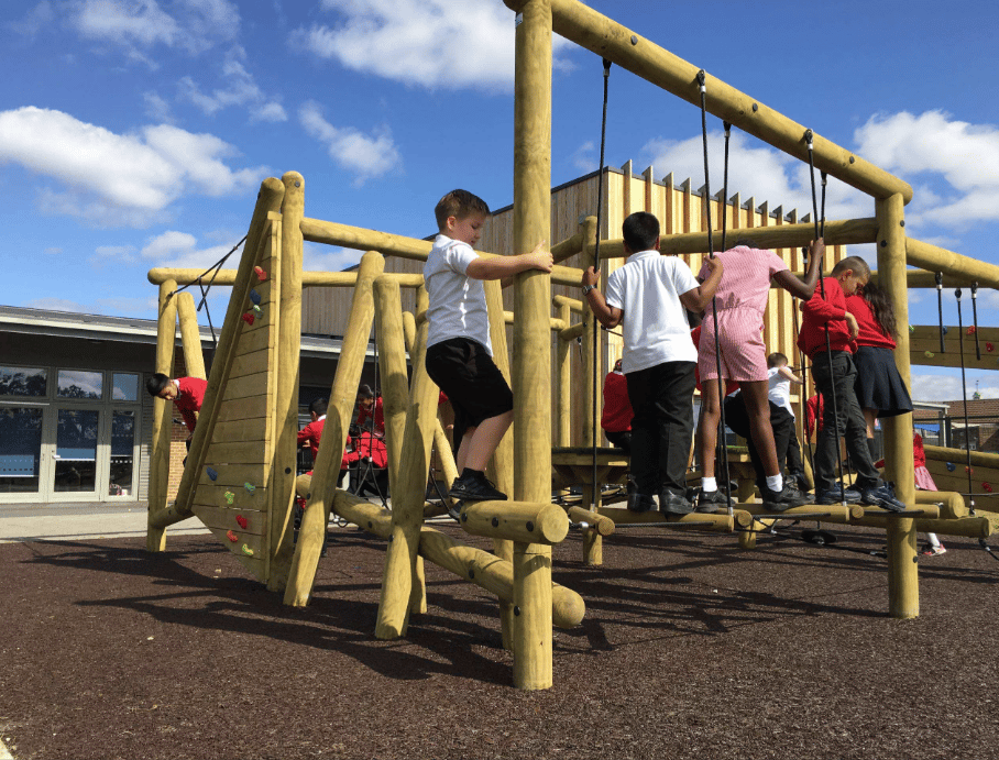 A Pentagon Play bespoke School Playground Scheme with children playing on the playground