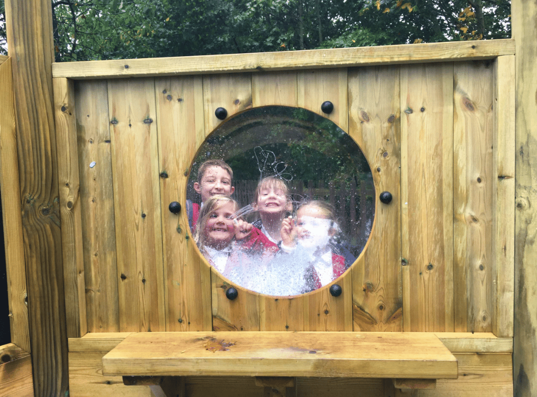 A Pentagon Play bespoke School Playground Scheme with children playing on the playground