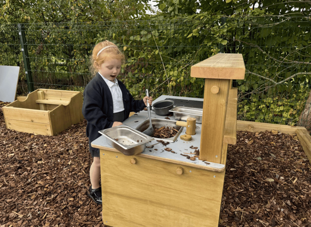 A Pentagon Play bespoke School Playground Scheme with children playing on the playground