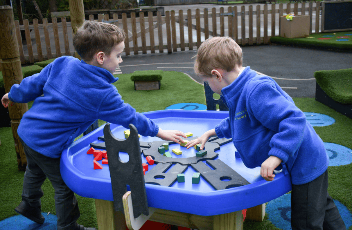 A Pentagon Play bespoke School Playground Scheme with children playing on the playground