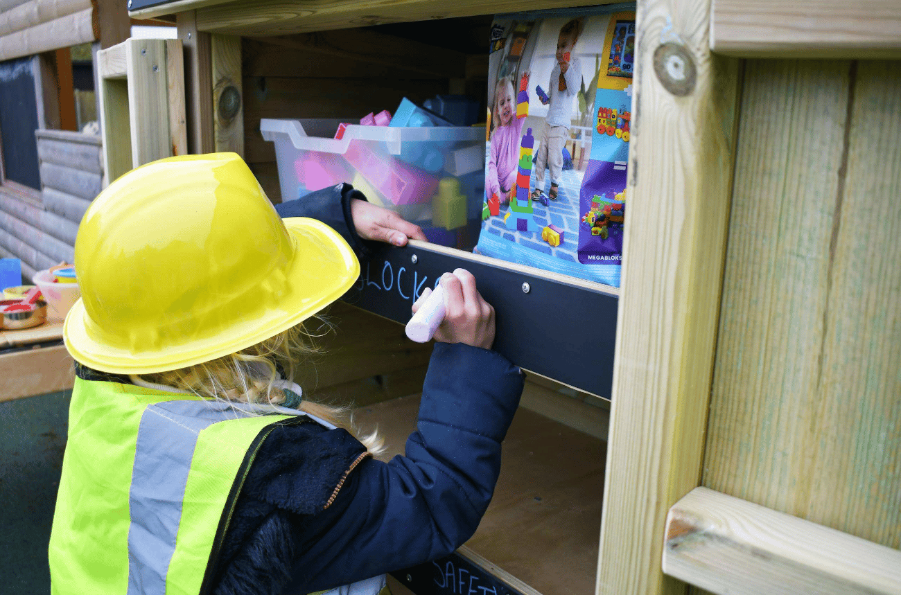 A Pentagon Play bespoke School Playground Scheme with children playing on the playground