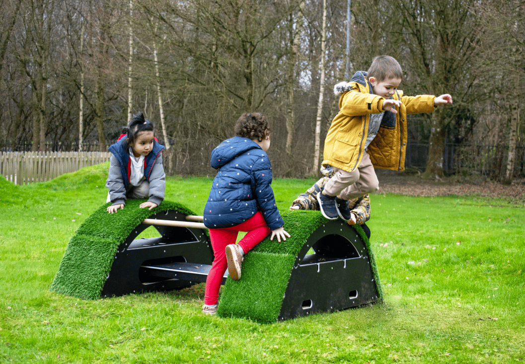 A Pentagon Play bespoke School Playground Scheme with children playing on the playground