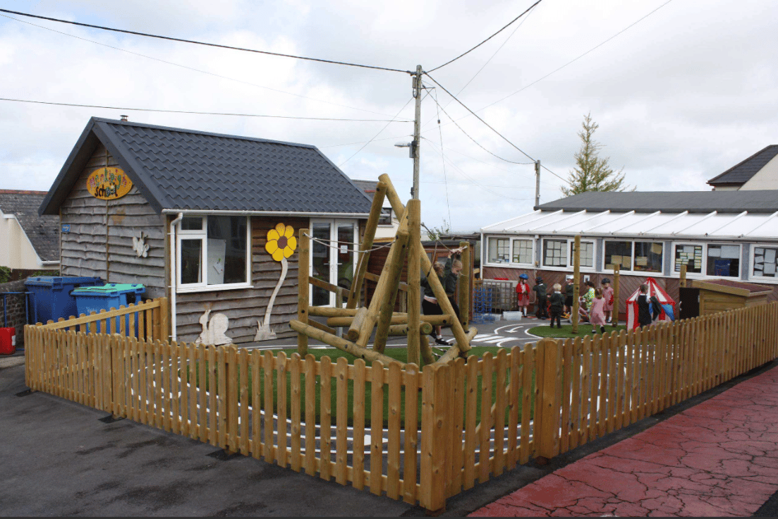 A Pentagon Play bespoke School Playground Scheme with children playing on the playground