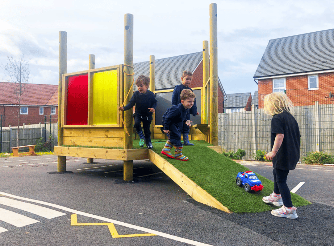 A Pentagon Play bespoke School Playground Scheme with children playing on the playground