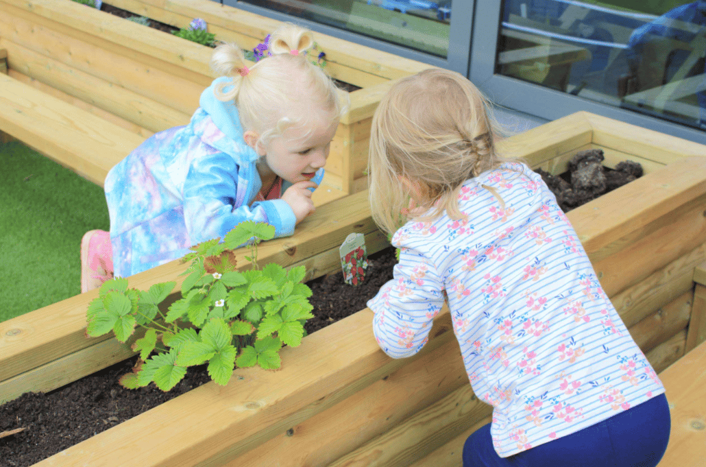 A Pentagon Play bespoke School Playground Scheme with children playing on the playground