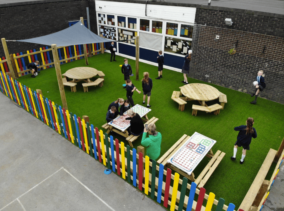 A Pentagon Play bespoke School Playground Scheme with children playing on the playground