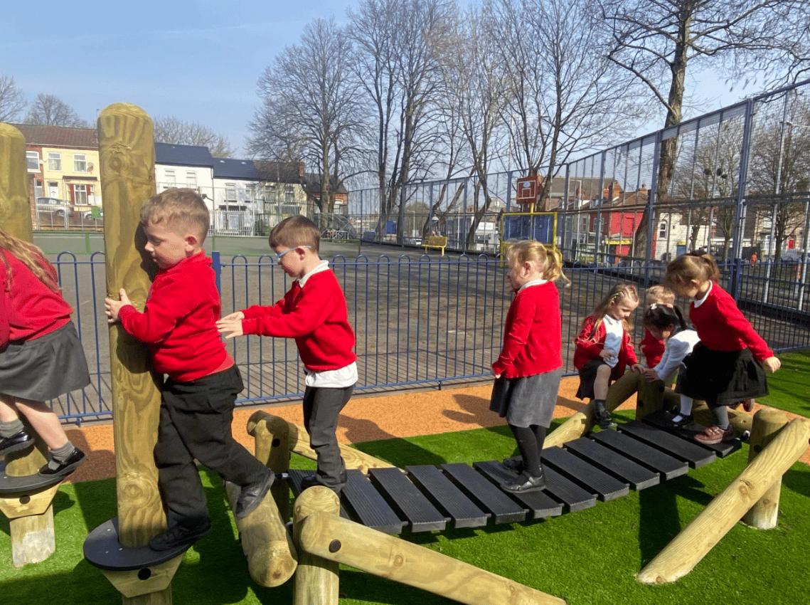 A Pentagon Play bespoke School Playground Scheme with children playing on the playground