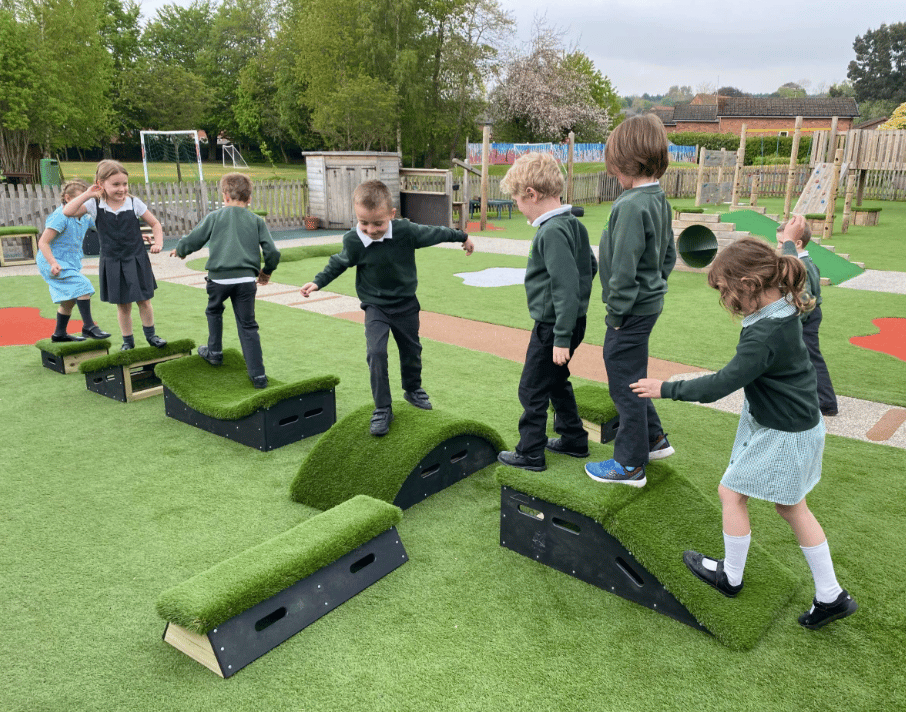 A Pentagon Play bespoke School Playground Scheme with children playing on the playground