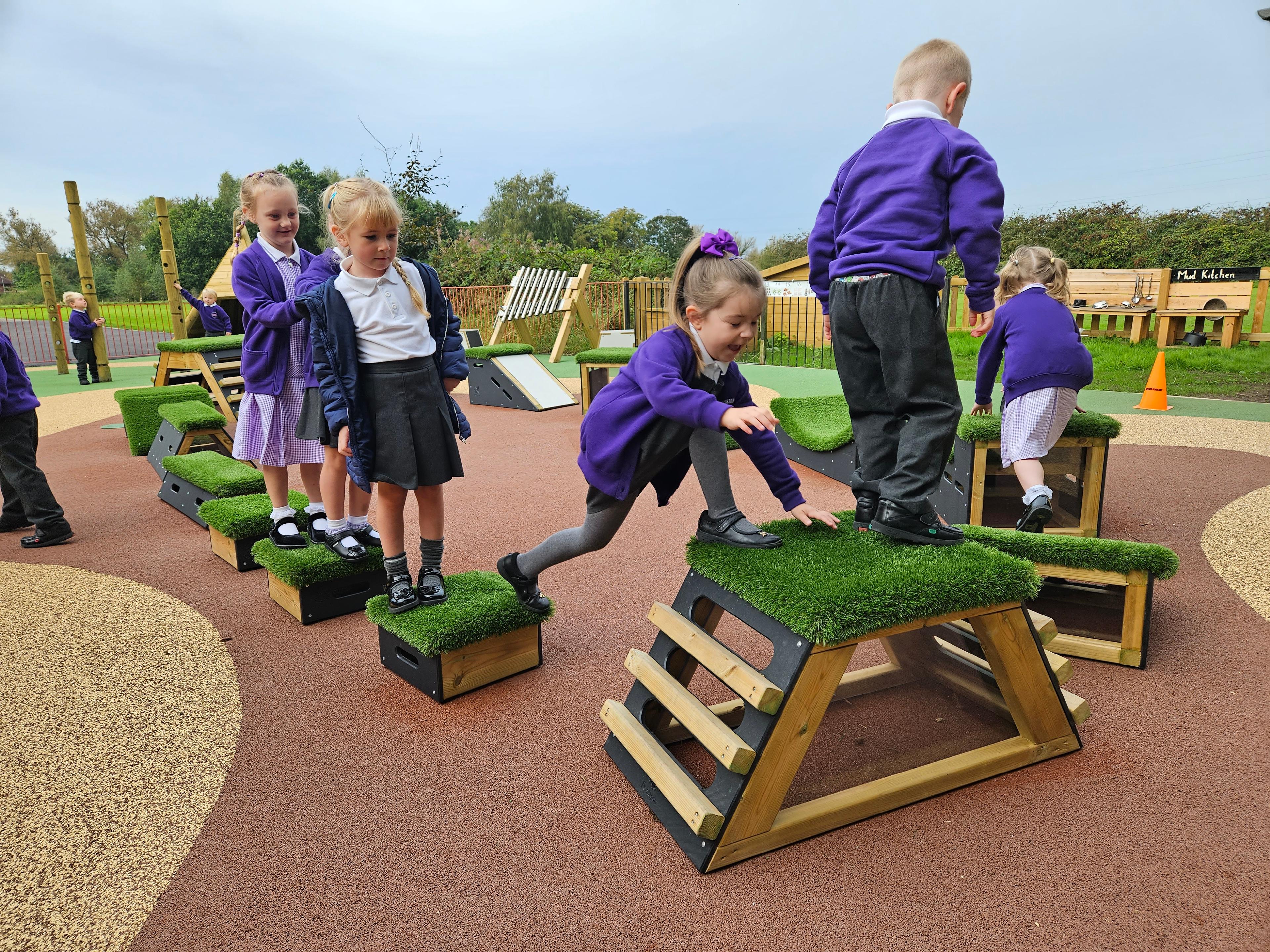 A Pentagon Play bespoke School Playground Scheme with children playing on the playground