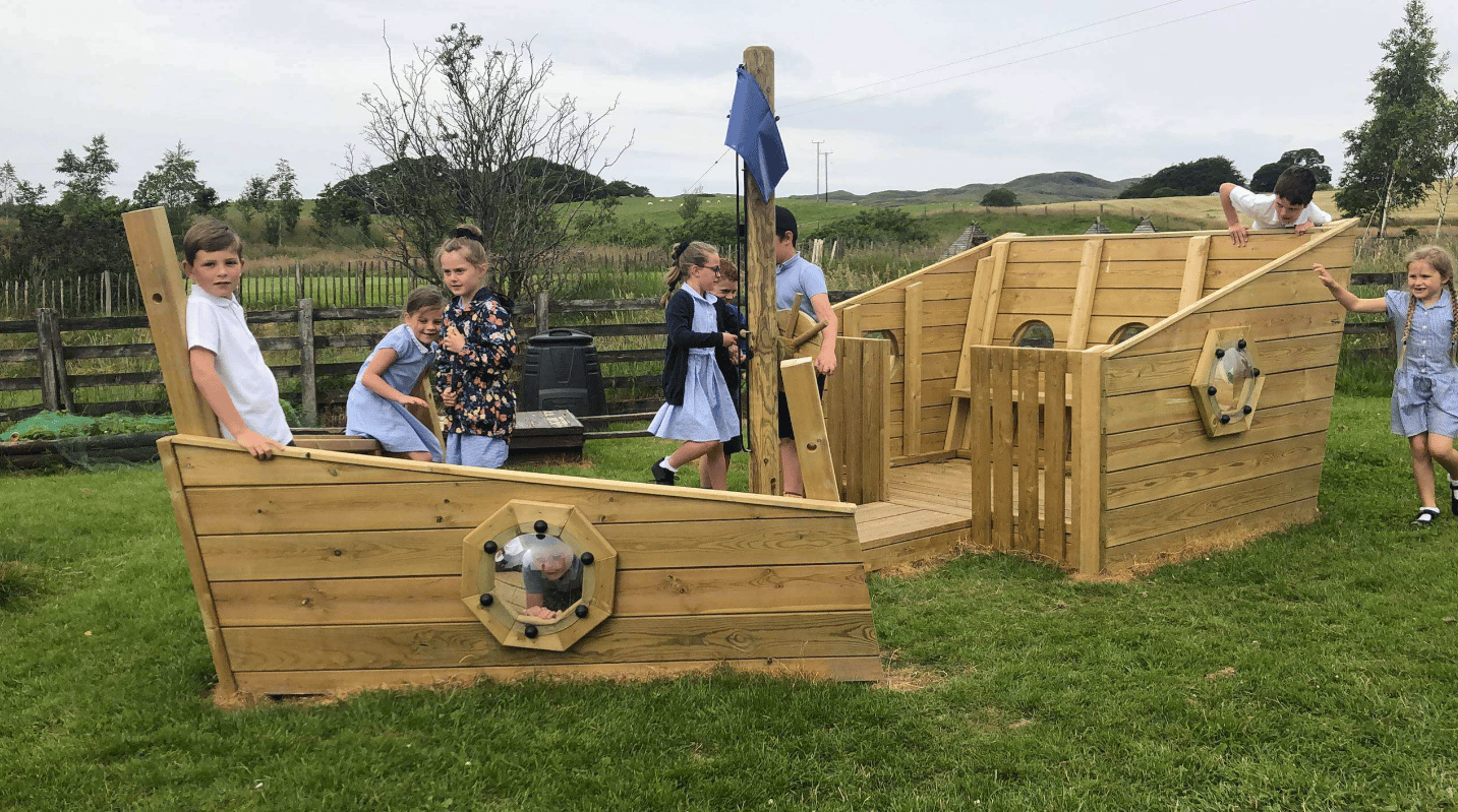 A Pentagon Play bespoke School Playground Scheme with children playing on the playground