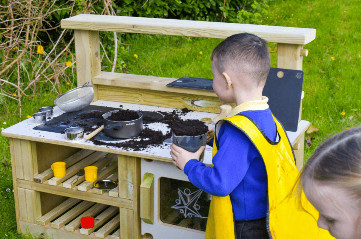 A Pentagon Play bespoke School Playground Scheme with children playing on the playground