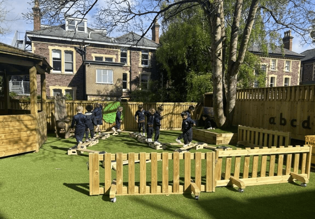 A Pentagon Play bespoke School Playground Scheme with children playing on the playground
