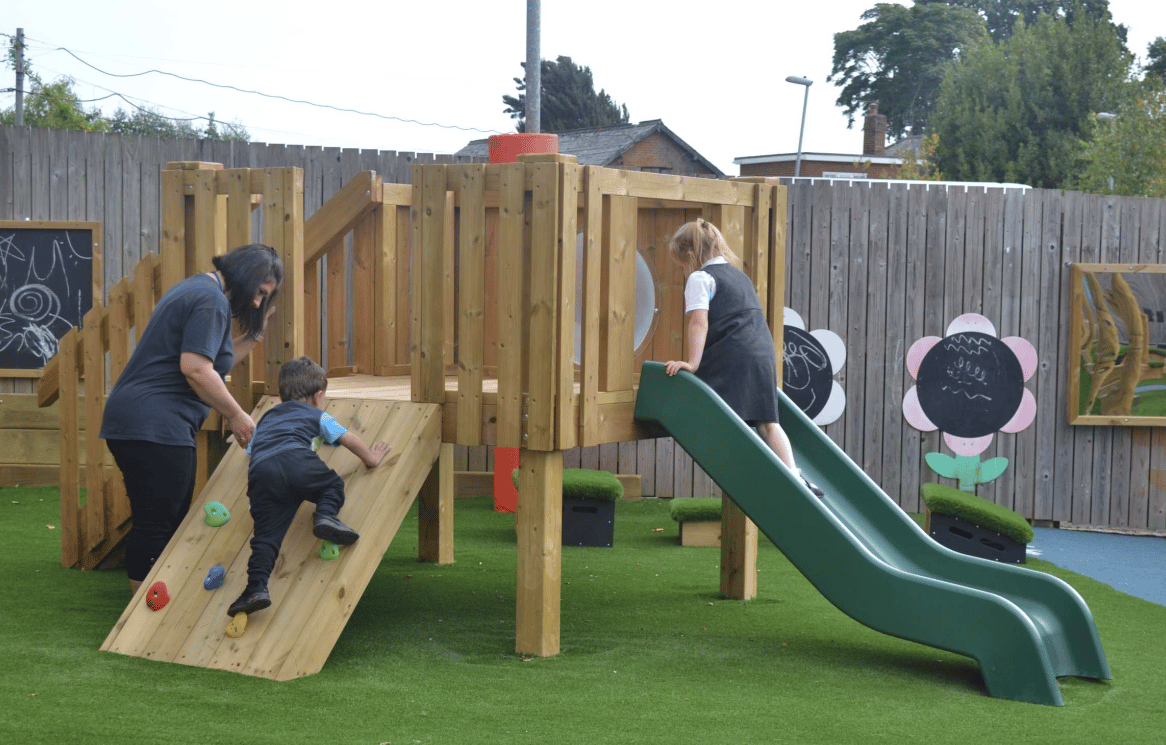 A Pentagon Play bespoke School Playground Scheme with children playing on the playground