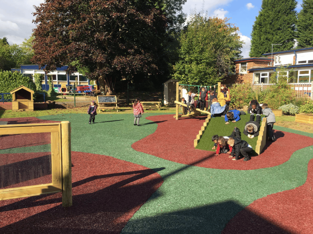 A Pentagon Play bespoke School Playground Scheme with children playing on the playground