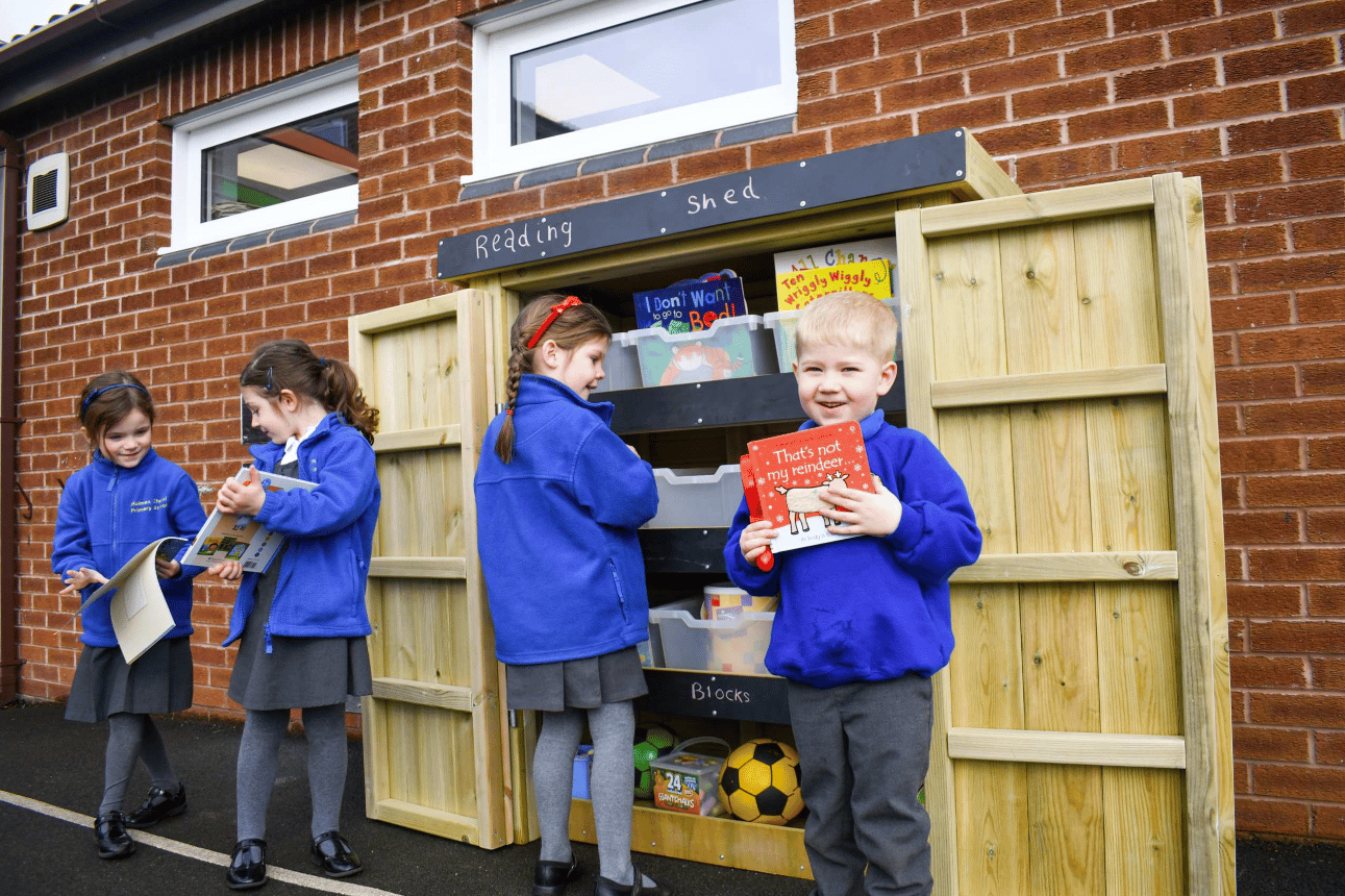 A Pentagon Play bespoke School Playground Scheme with children playing on the playground