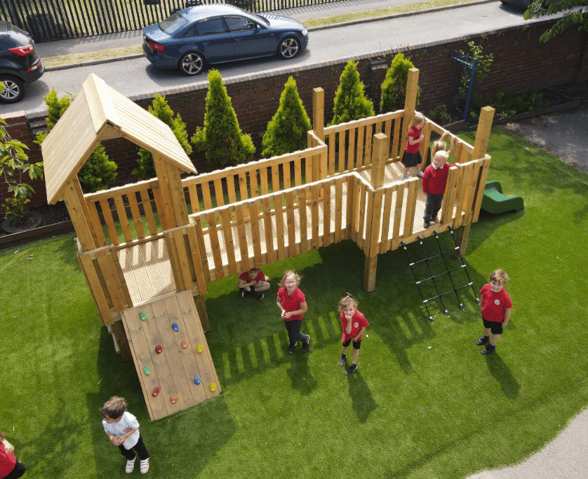 A Pentagon Play bespoke School Playground Scheme with children playing on the playground