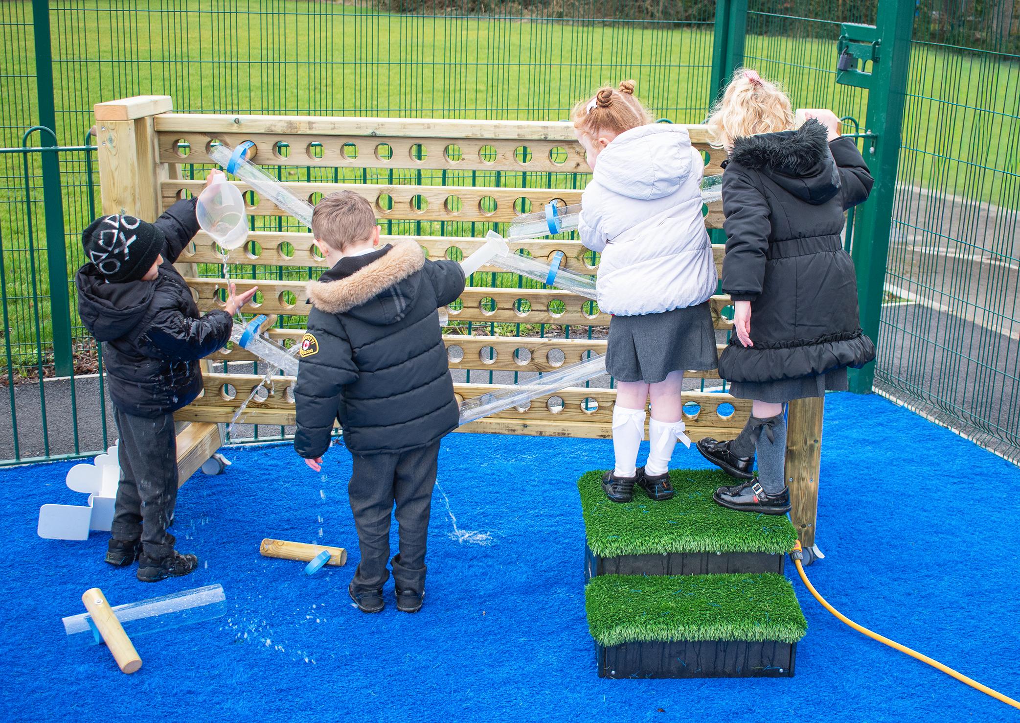 A Pentagon Play bespoke School Playground Scheme with children playing on the playground