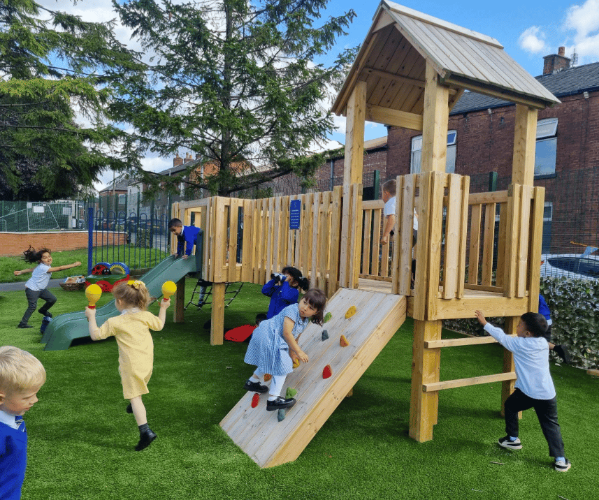 A Pentagon Play bespoke School Playground Scheme with children playing on the playground