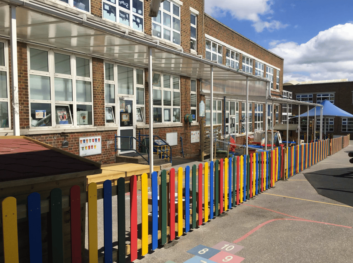 A Pentagon Play bespoke School Playground Scheme with children playing on the playground