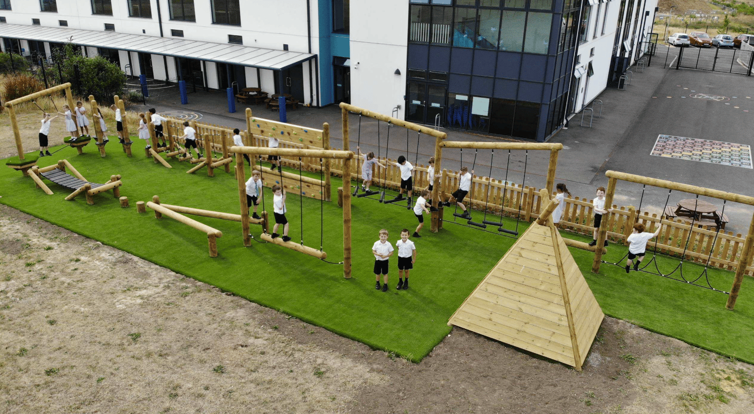 A Pentagon Play bespoke School Playground Scheme with children playing on the playground