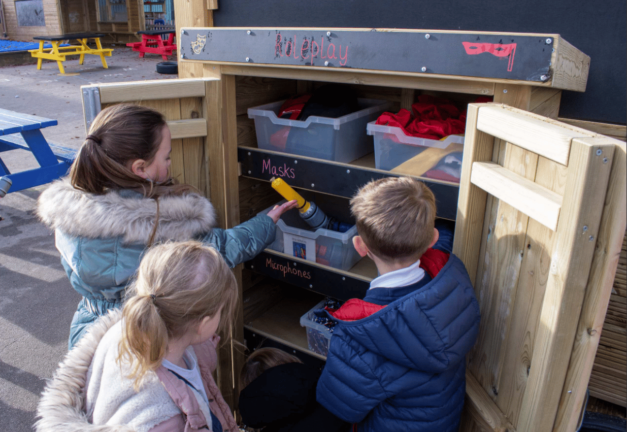 A Pentagon Play bespoke School Playground Scheme with children playing on the playground