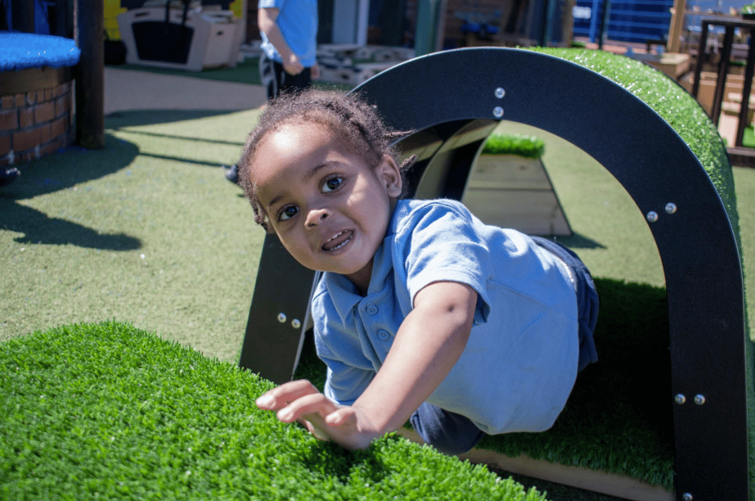 A Pentagon Play bespoke School Playground Scheme with children playing on the playground