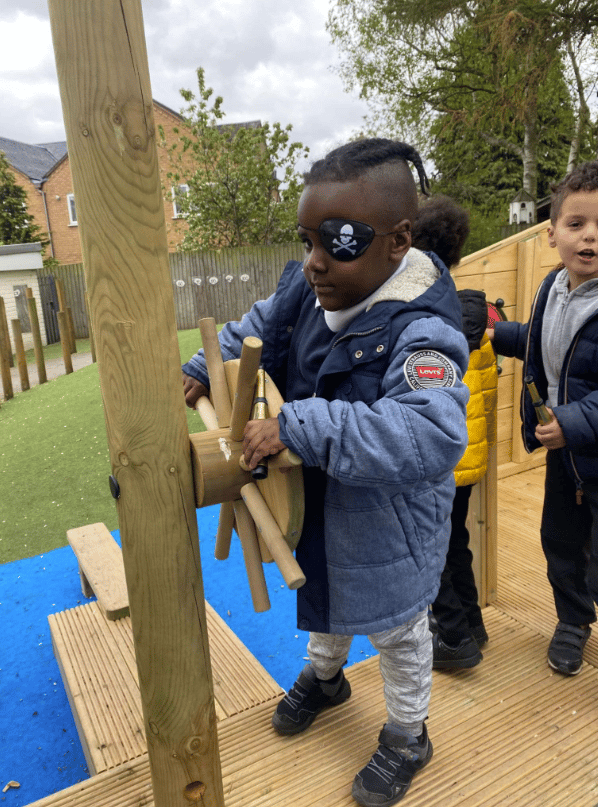 A Pentagon Play bespoke School Playground Scheme with children playing on the playground