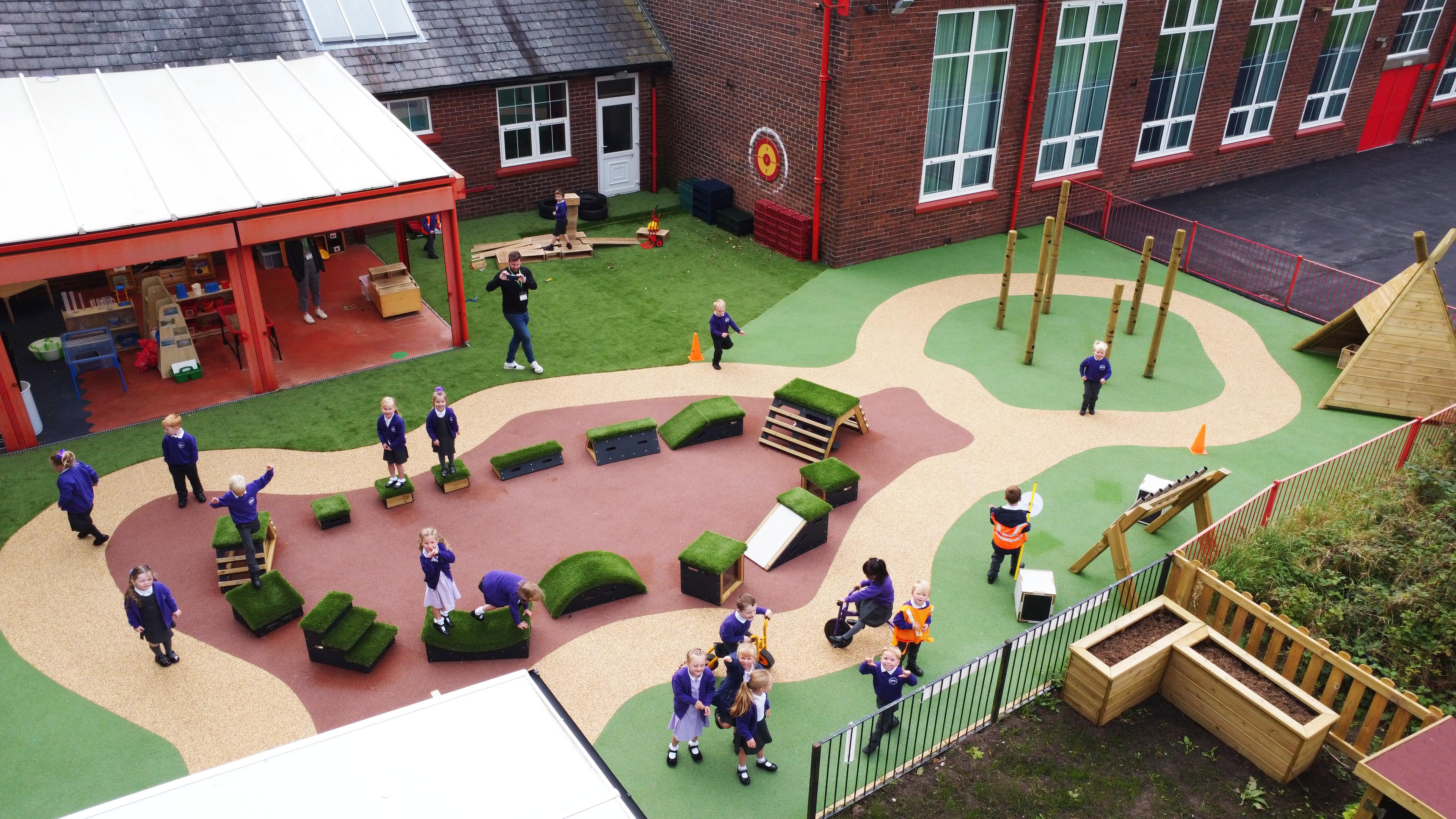 A Pentagon Play bespoke School Playground Scheme with children playing on the playground