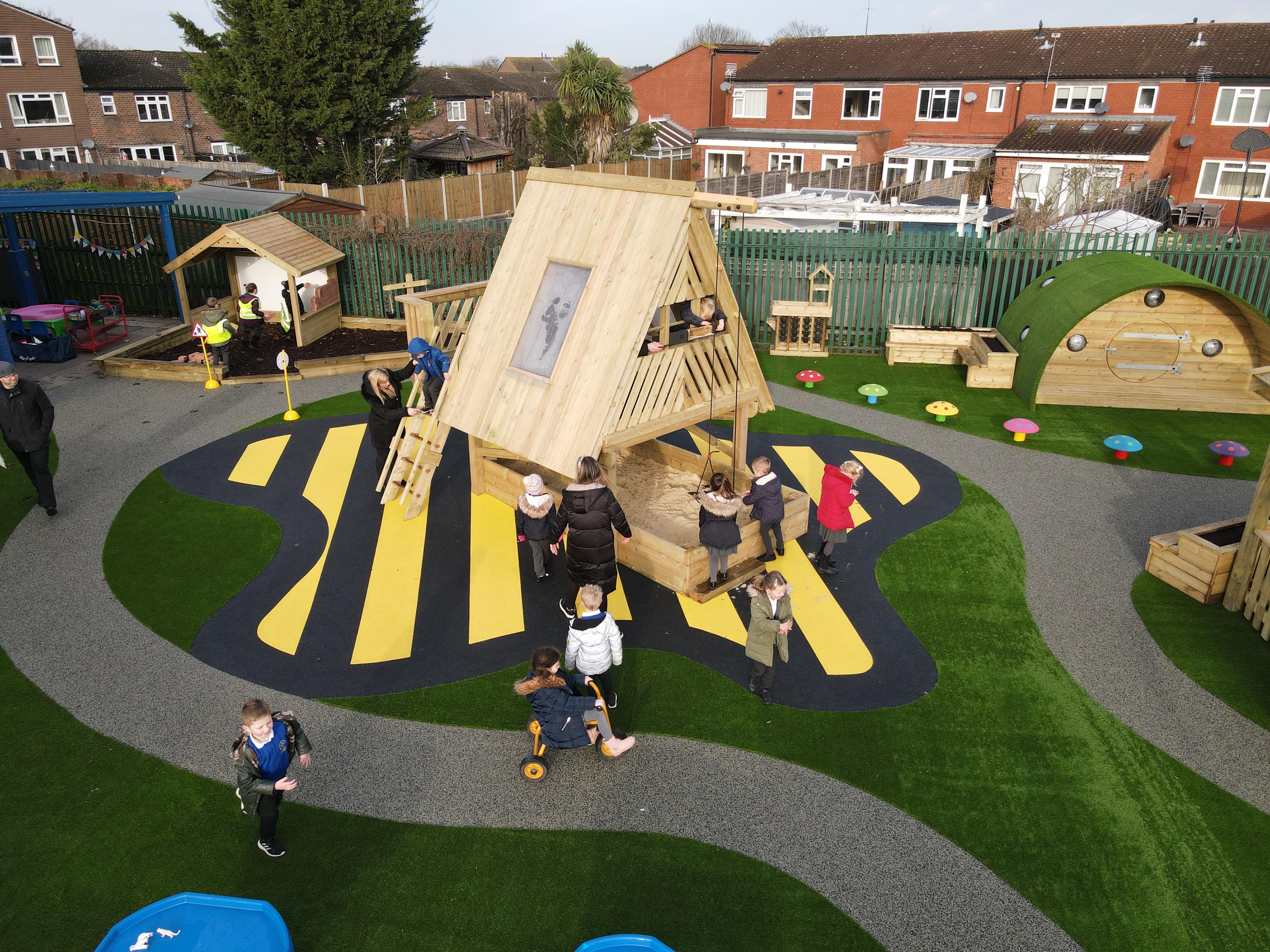 A Pentagon Play bespoke School Playground Scheme with children playing on the playground