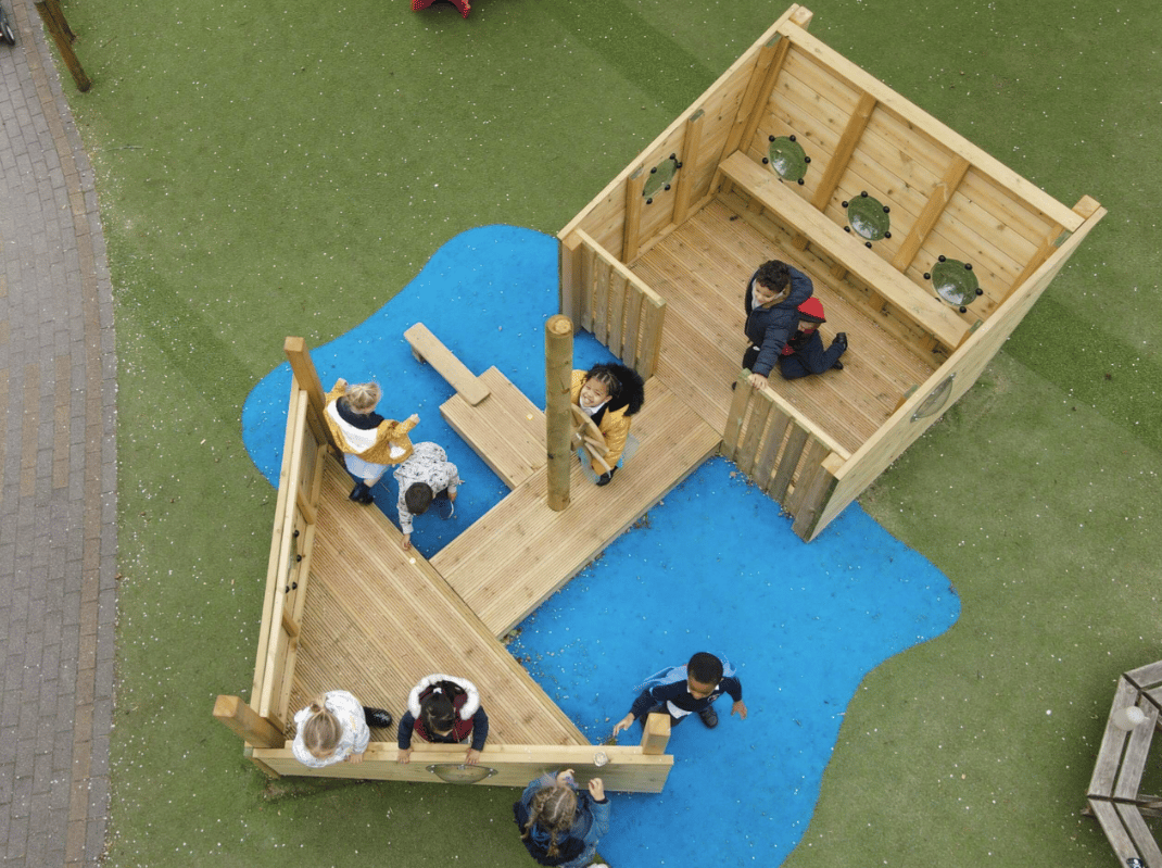 A Pentagon Play bespoke School Playground Scheme with children playing on the playground