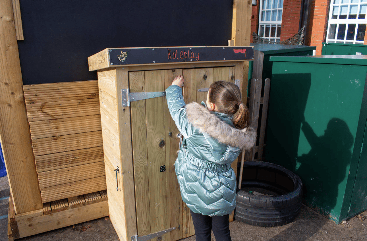A Pentagon Play bespoke School Playground Scheme with children playing on the playground