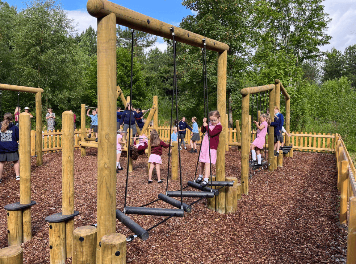 A Pentagon Play bespoke School Playground Scheme with children playing on the playground